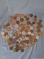 Overhead view of entire assortment of mixed coins spread on cloth