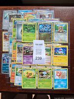 Full spread of roughly 45 Pokémon cards fanned out
