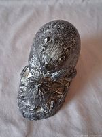 Top view of beaver resin figurine showing antiqued silver finish and detailed carving