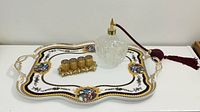 Overall shot of porcelain tray with perfume atomizer and lipstick holder