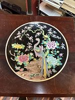 Front of charger showing full enamel design on black ground