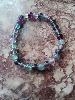 Full bracelet laid flat showing multicolour fluorite beads