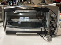 Front view of Hamilton Beach toaster oven with power cord visible