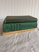 Stack of three vintage cookbooks showing spines and covers
