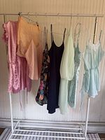 Full rack view showing eight hanging lingerie pieces in assorted colours and styles