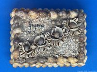 Top view of box showing seashell decoration and overall condition