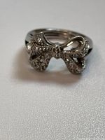 Front view of bow ring showing pavé cubic zirconia and overall design