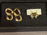 Overall view showing both pairs of earrings in lot
