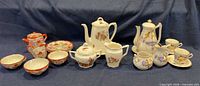 Group shot of all three partial tea sets