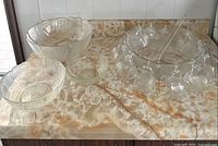 Complete punch set on countertop: punch bowl, ladle, 12 cups, 3 serving bowls