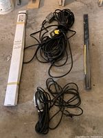 Overview showing picket box, door sweep, coiled long extension cord with outlet box, shorter cord with work light