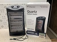 Heater unit beside original box showing overall appearance