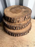 Three wood slice stands stacked showing bark edges and thickness