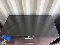 Top view showing black metal surface and wear