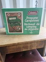 Front of boxed Coleman propane camp stove