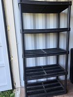 Assembled black plastic five-shelf unit