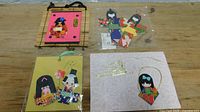 Top view of bamboo wall hanging, two greeting cards and plastic bag of cutouts