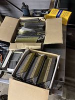 Open boxes showing multiple strips of galvanized ring shank nails