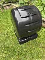 Overall view of black Envirocycle compost drum seated on base