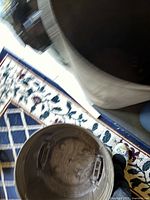 View inside brass garbage can showing removable lid and interior