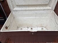 Open box showing white interior, metal hasp, hinge detail