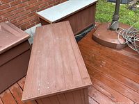 Both wooden outdoor storage benches on deck