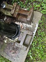 Two Toledo cast iron counterweights on concrete base