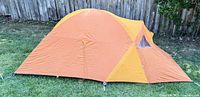 Tent fully assembled with rainfly and vestibule shown side view on grass