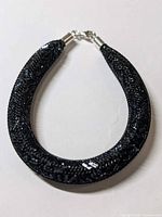 Full view of black mesh tube bracelet with crystals and clasp