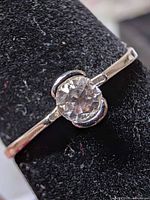Front view of sterling silver ring showing clear stone setting