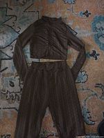 Full view of brown quilted jacket and matching pants laid flat