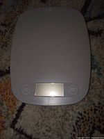 Top view of Greater Goods digital kitchen scale showing gray surface, LCD, Unit and Zero buttons