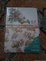 Front view of sealed floral journal showing cover design, size and sheet count label