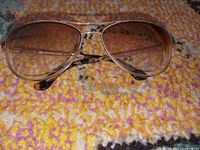 Front view of Jennifer Lopez gold and tortoise aviator sunglasses showing frame and lenses