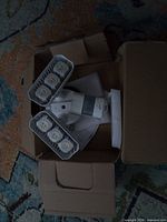 Overall view of LED floodlight in box showing three head design