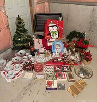 Overall lot with dinnerware set, tree, figurines, cards, gift bags, glass plate