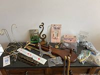 Overview of assorted display stands, hooks, rings and packaged items on dark surface
