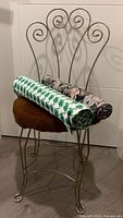 Metal chair with two fabric rolls on seat