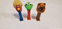 Front view of three character PEZ dispensers