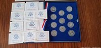 Open presentation case showing 12 medals and pamphlets
