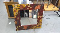 Front view showing entire square mirror and decorative frame