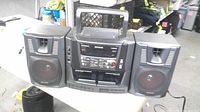 Front view of Aiwa boombox with speakers attached and handle raised