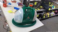 Front view of Bissell Little Green cleaner on table