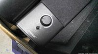 Bose speaker with volume knob and headphone jack in storage bin
