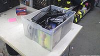 Tote of Garmin GPS units and accessories on table