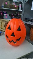 front view of orange blow mold pumpkin showing facial features