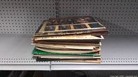 Side view of entire stack of vinyl LPs on shelf
