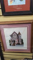 Front view of framed needlepoint artwork showing image, mats and frame