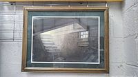 Overall view of framed, matted painting showing barn interior scene