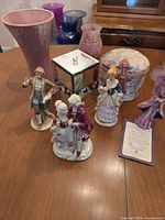 Entire lot showing figurines, vases and boxes on table